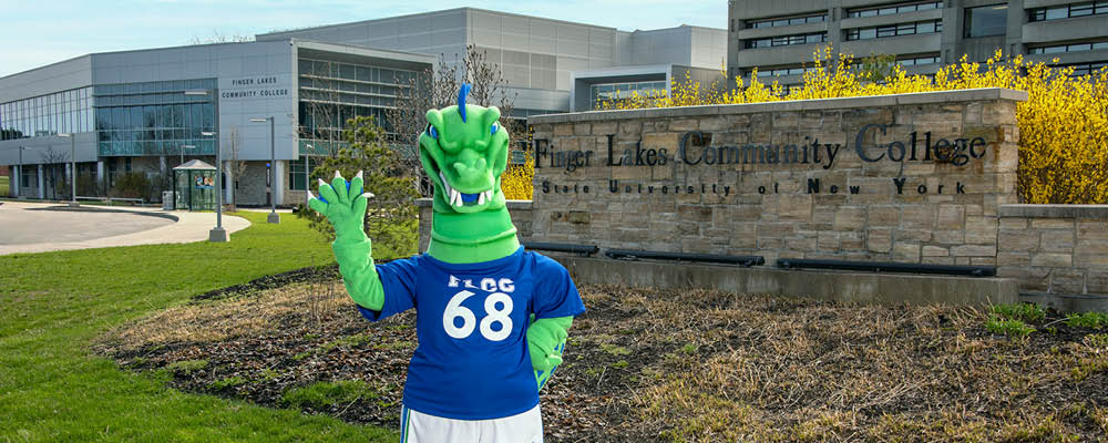 Flick, the FLCC mascot, waving to new students in front of main campus.